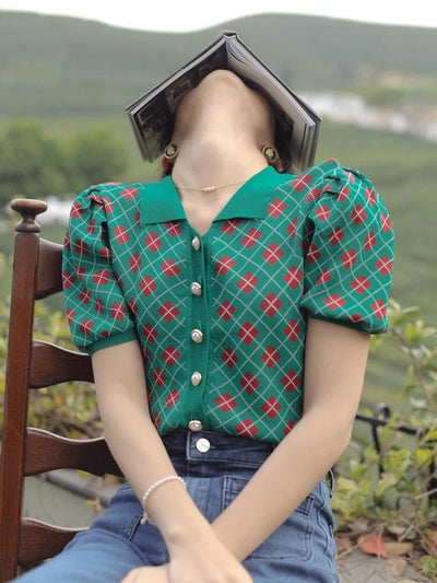 This delicate red, green and white button-down argyle blouse is just right for every and any occasion this season. Plunging into a high v neck adorned with sweet pearl buttons to give it that cozy vintage feel. Wear it with jeans/pants or a skirt. Its short slightly puffy sleeves give this shirt a bit of a play, wear it alone or with a fluffy overcoat. Made with fine yarn cotton every detail hand measured. Runs small and is one size