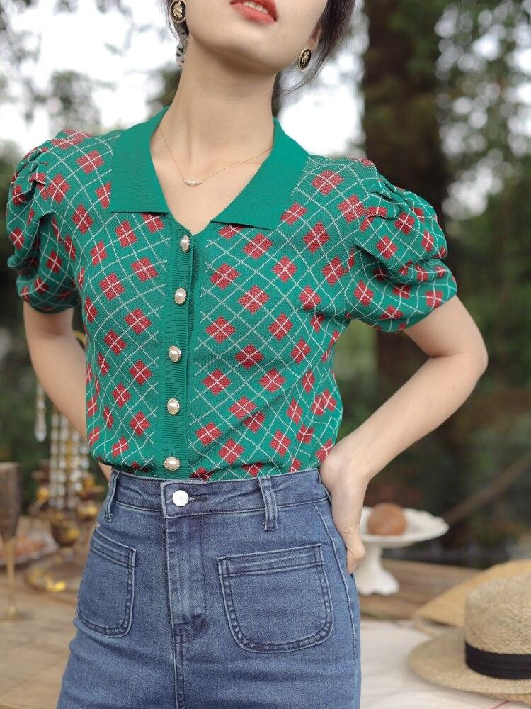 This delicate red, green and white button-down argyle blouse is just right for every and any occasion this season. Plunging into a high v neck adorned with sweet pearl buttons to give it that cozy vintage feel. Wear it with jeans/pants or a skirt. Its short slightly puffy sleeves give this shirt a bit of a play, wear it alone or with a fluffy overcoat. Made with fine yarn cotton every detail hand measured.